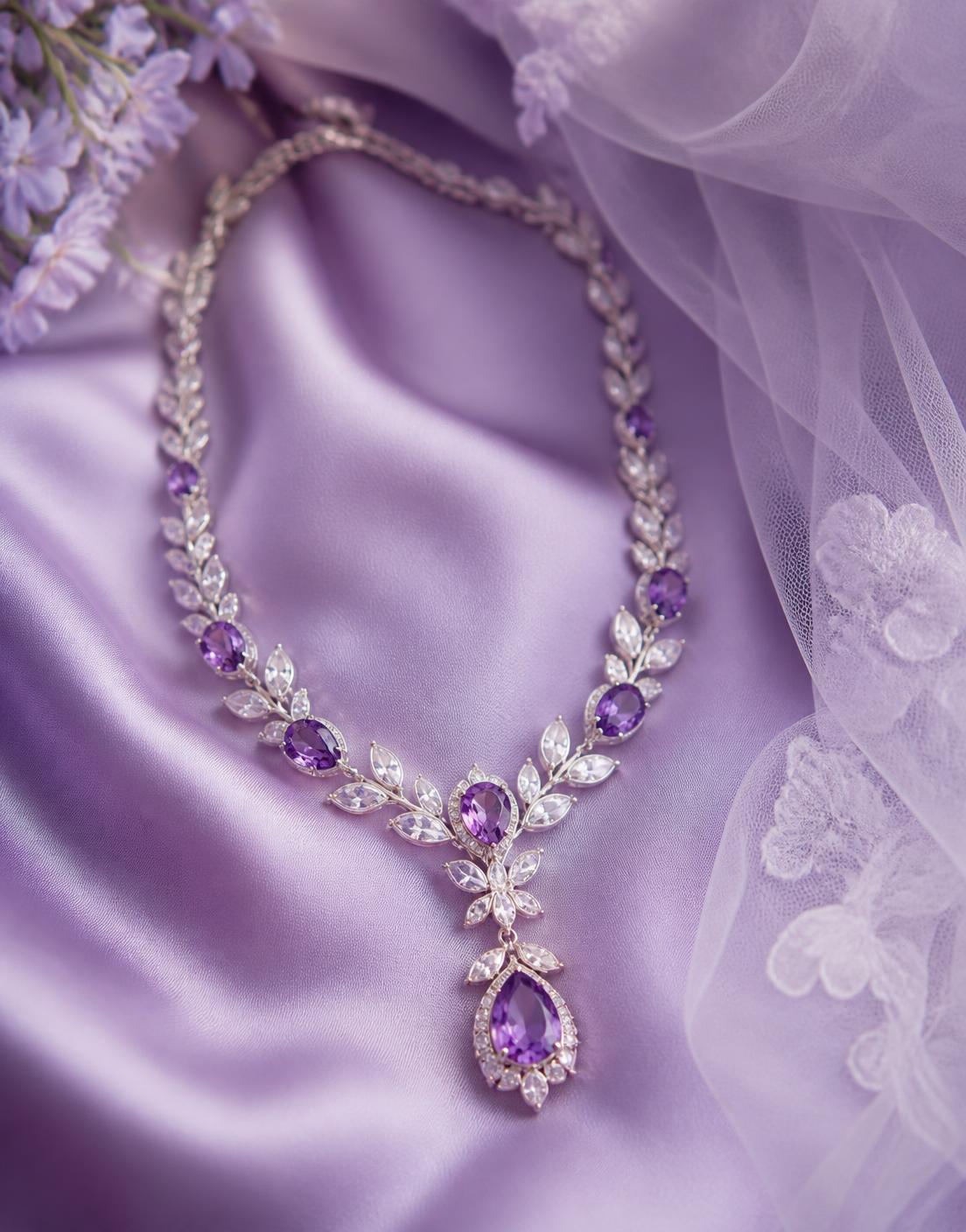 Amethyst and white gold bridal necklace on lilac silk beside a tulle veil